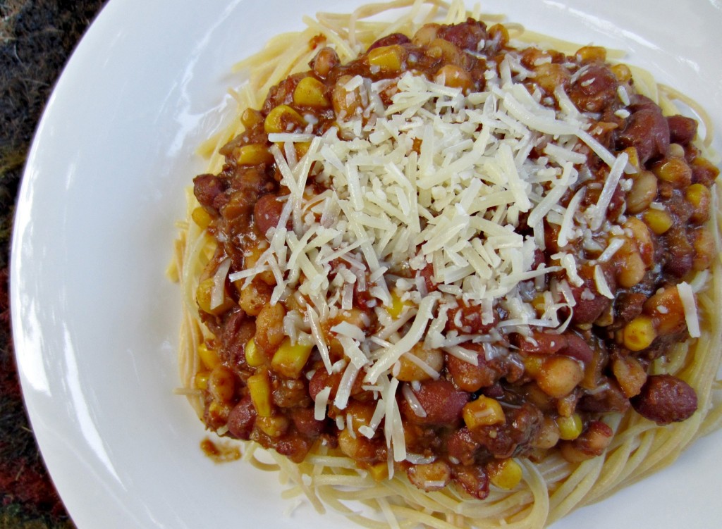 chili over noodles with beans and parmesan